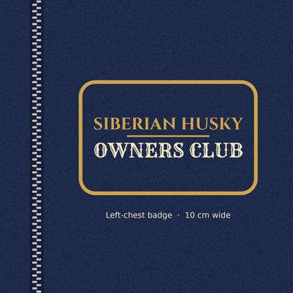 Close-up of the gold-outlined Siberian Husky Owners Club badge on the left chest of the men's zip hoodie
