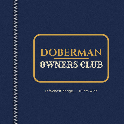 Close-up of the gold-outlined Doberman Owners Club badge on the left chest of the men's zip hoodie