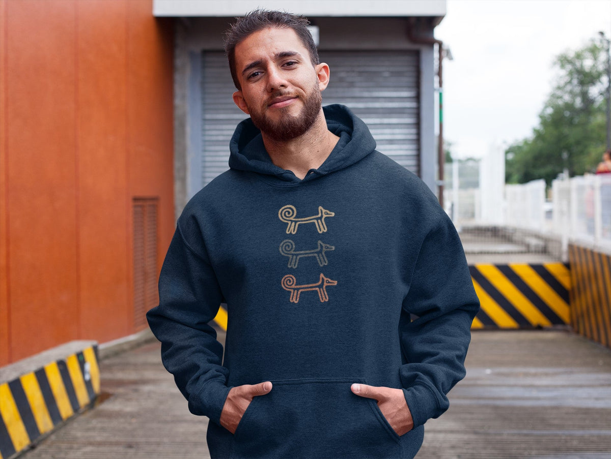 Man against an orange wall in the navy Dog Totem men's hoodie