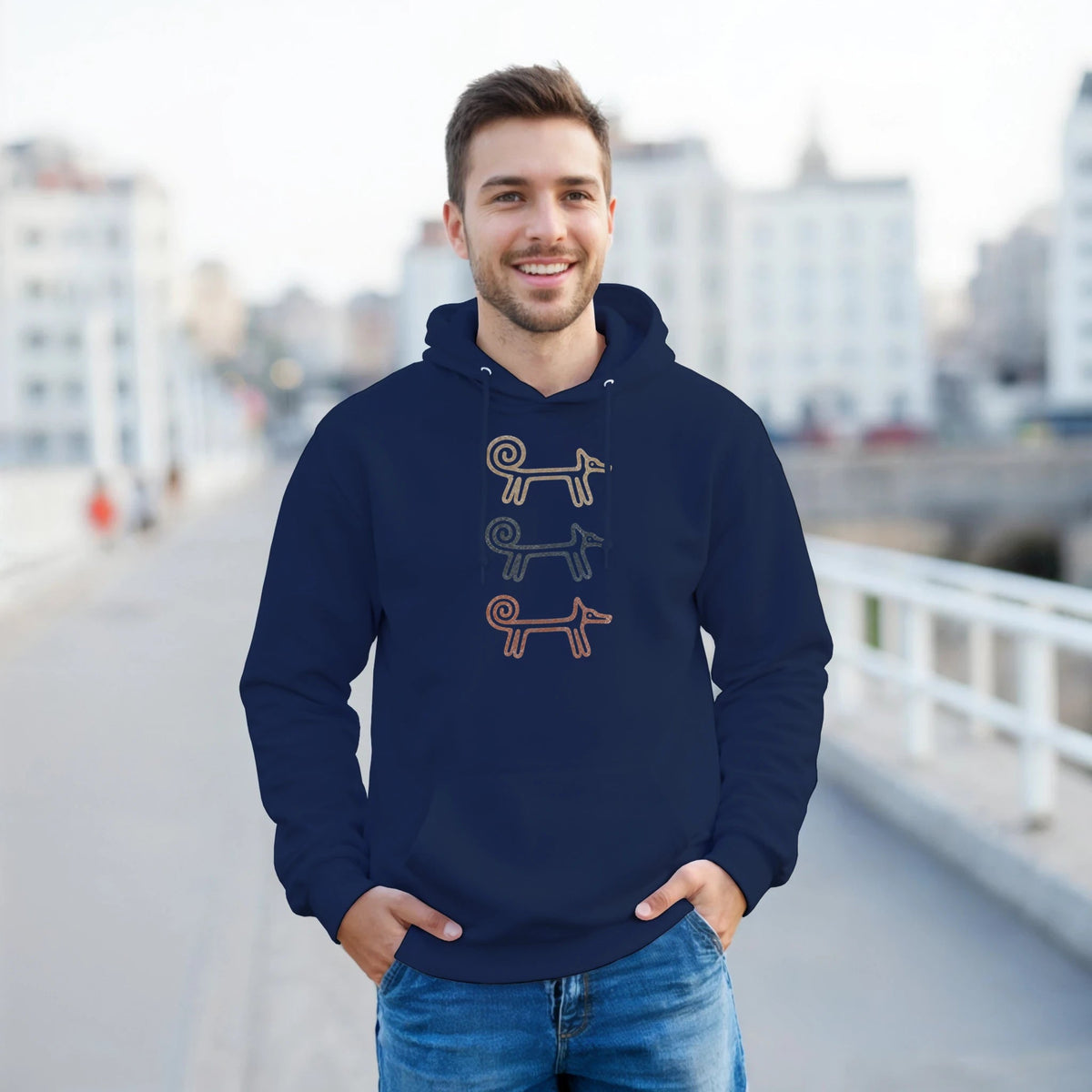 Man on a city balcony wearing the navy Dog Totem men's hoodie