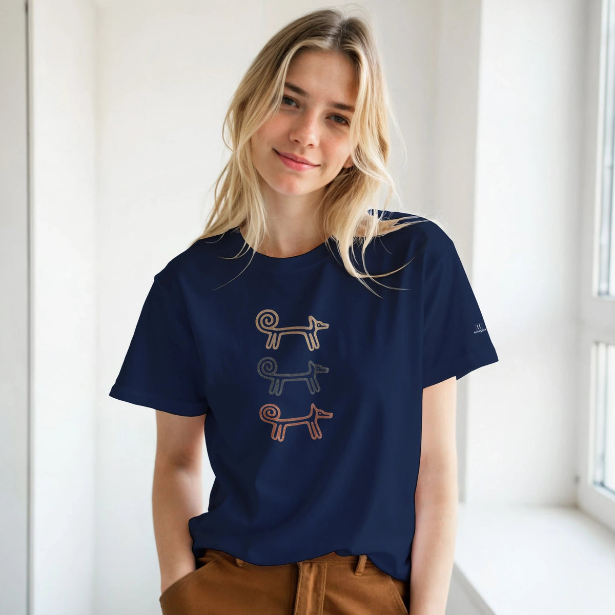 Smiling woman by a window in the navy Dog Totem women's T-shirt