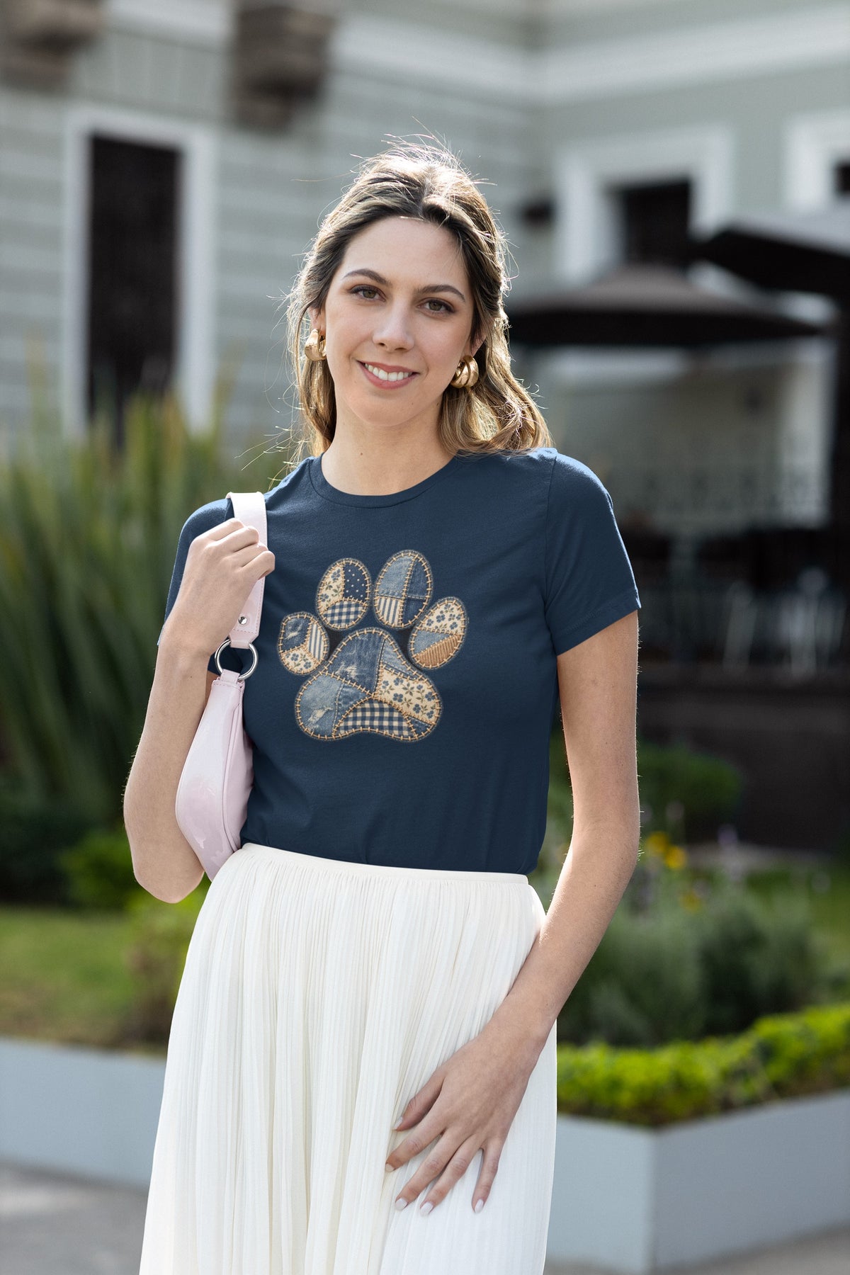 Smiling woman wearing the Navy Faux Patchwork Club Women's T-shirt with a white skirt